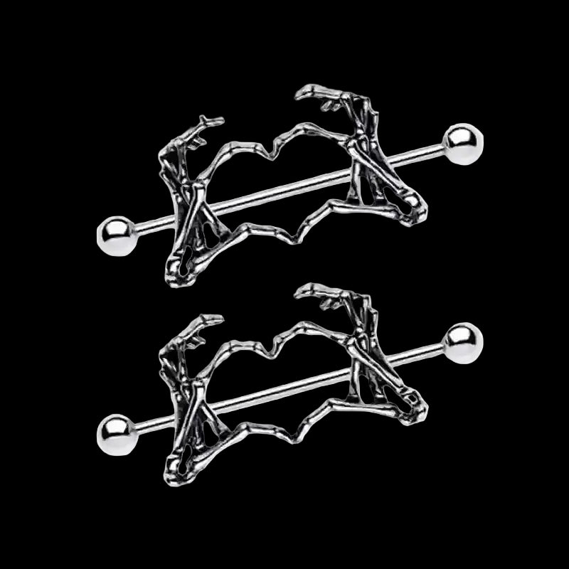 Skeleton hand heart nipple piercings